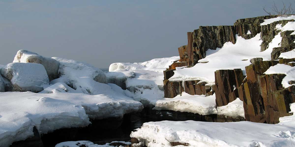 ice and snow on rocks of beaver bay shoreline of lake superior