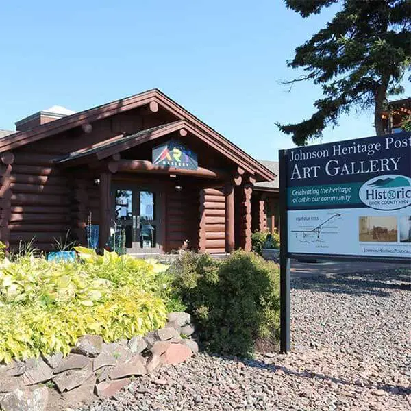 gardens and log building that is the johnson heritage post grand marais mn