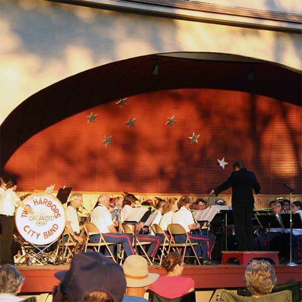 two harbors city band playing in bandshell at thomas owens park