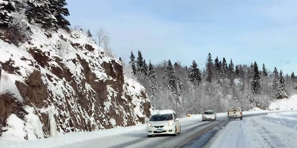 snow covered rocks and pine along snowy highway 61 up the north shore