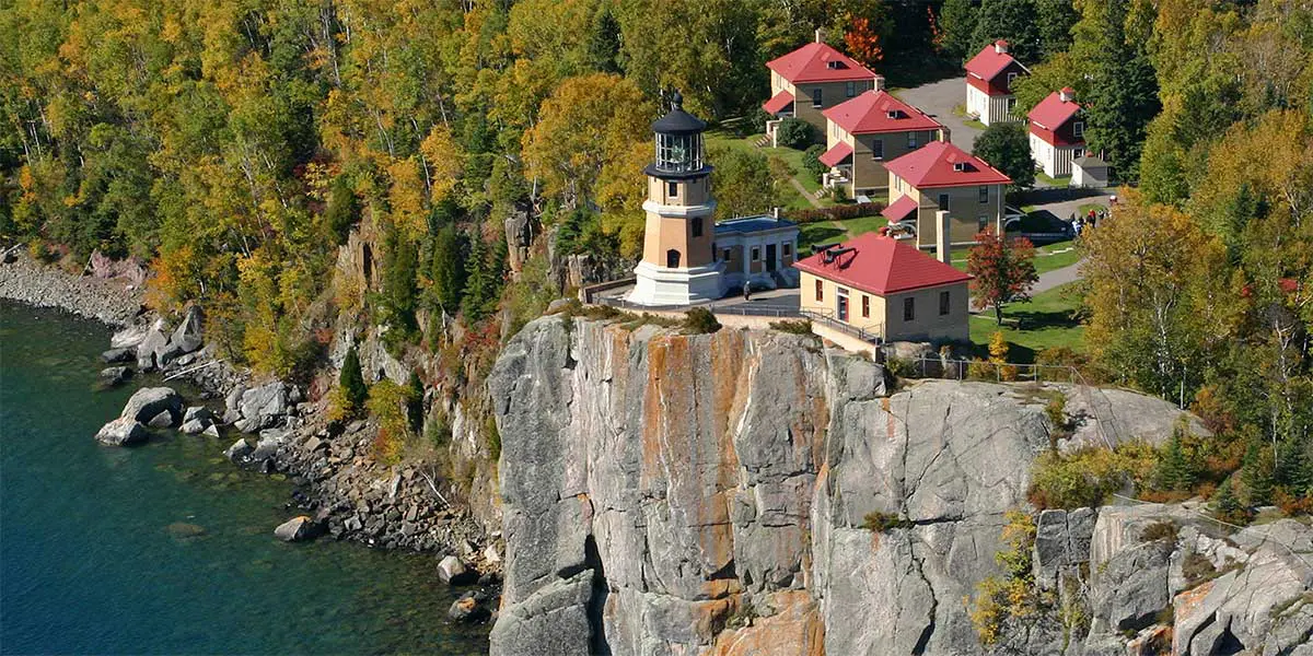 Split rock lighthouse in red roof buildings on Greycliff over Lake superior