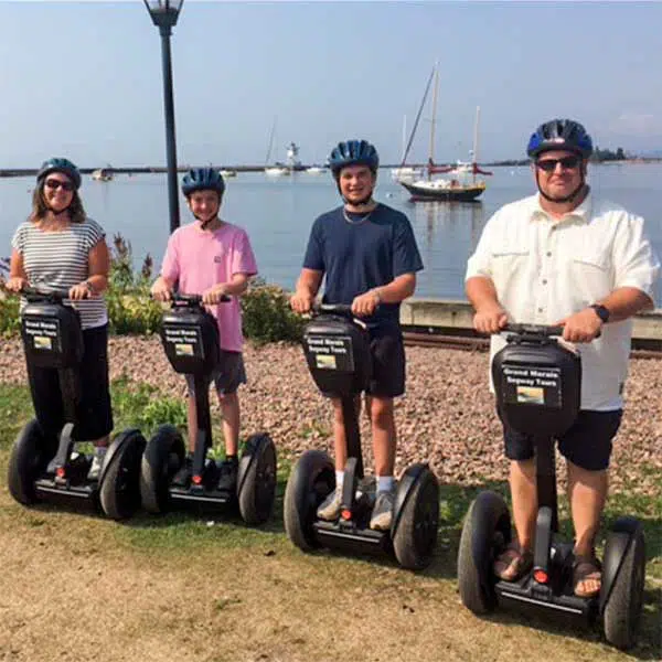 grand marais segway tour family in front of harbor