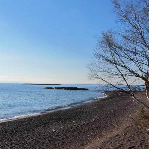 paradise beach cobblestones edge lake superior with a small island off shore