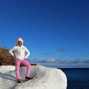 child snowshoeing at edge of lake superior