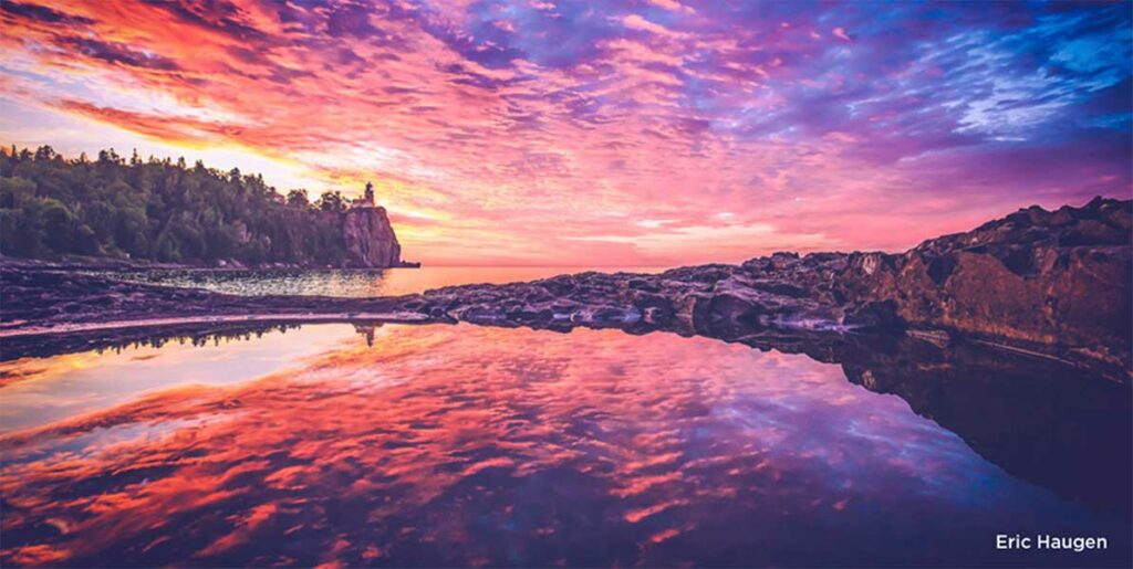 pinks oranges purples of sunrise with clouds over split rock lighthouse