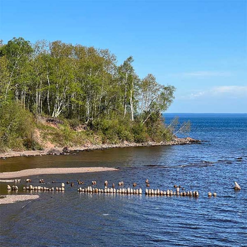 old-pilings-mouth-of-split-rock-river pilings poking out of lake superior at split rock river north shore minnesota