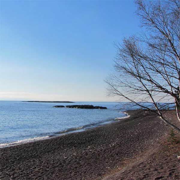 paradise beach cobblestones edge lake superior with a small island off shore