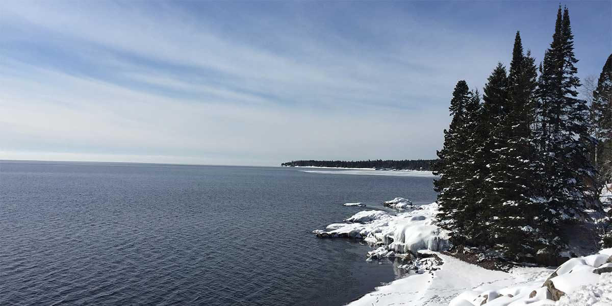 snow covered shoreline and pines along north shore of lake superior