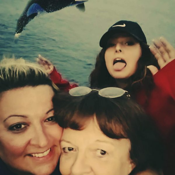 three generations of women from iowa pose with a leaping whale lake superior